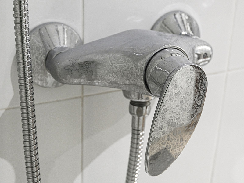 Hard water stains on shower faucet.
